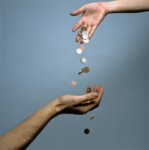 Hands dropping coins