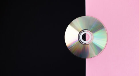 Płyta CD na czarno różowym tle.